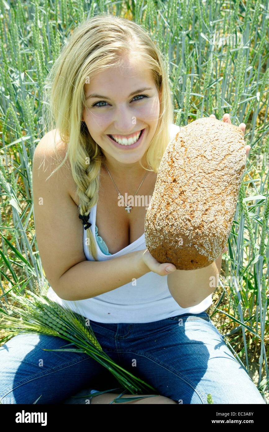 Woman with bread at a field Stock Photo