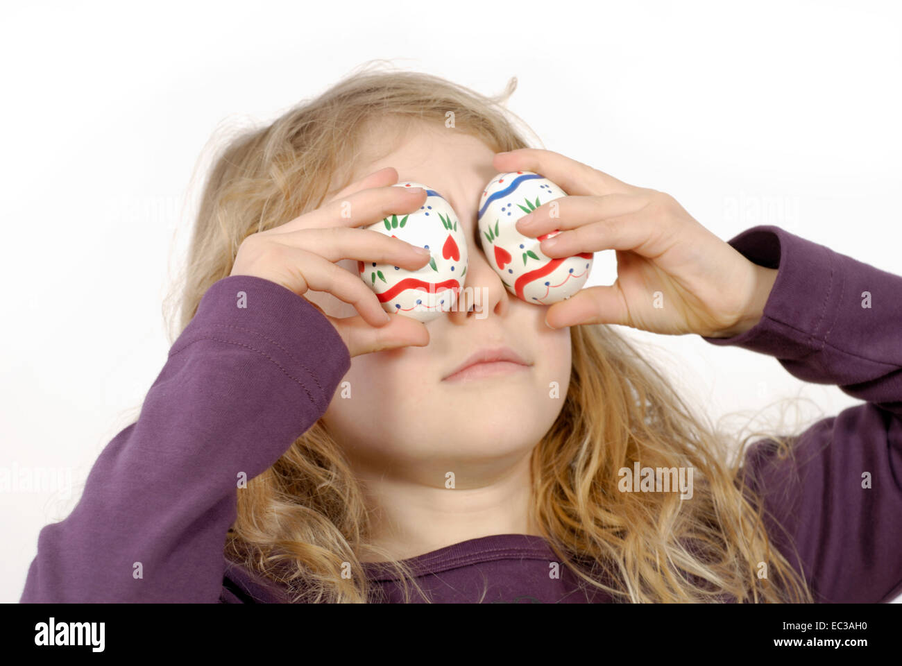 Little Girl with Easter Eggs on Eyes Stock Photo