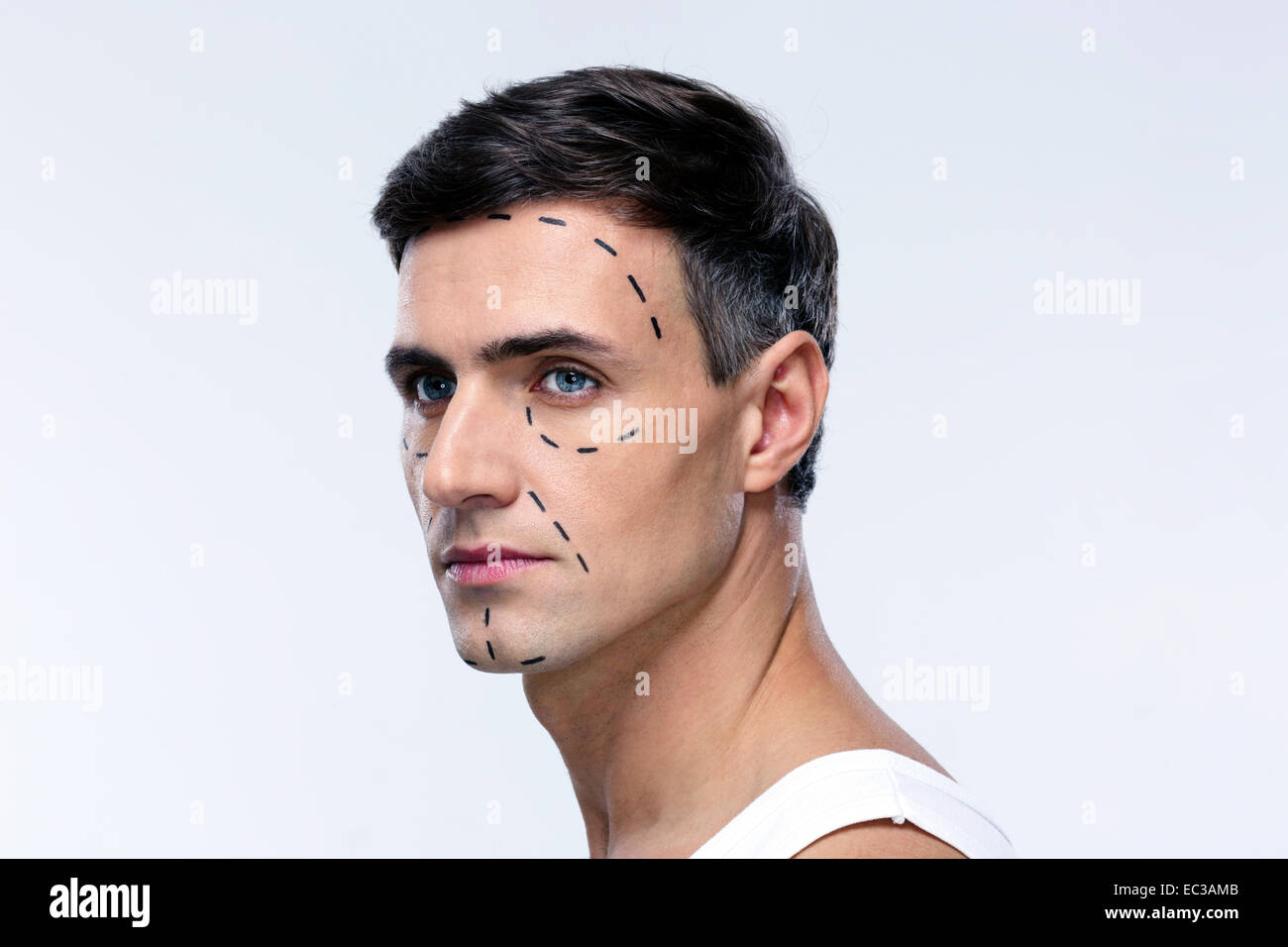 Man marked with lines for plastic surgery looking away Stock Photo