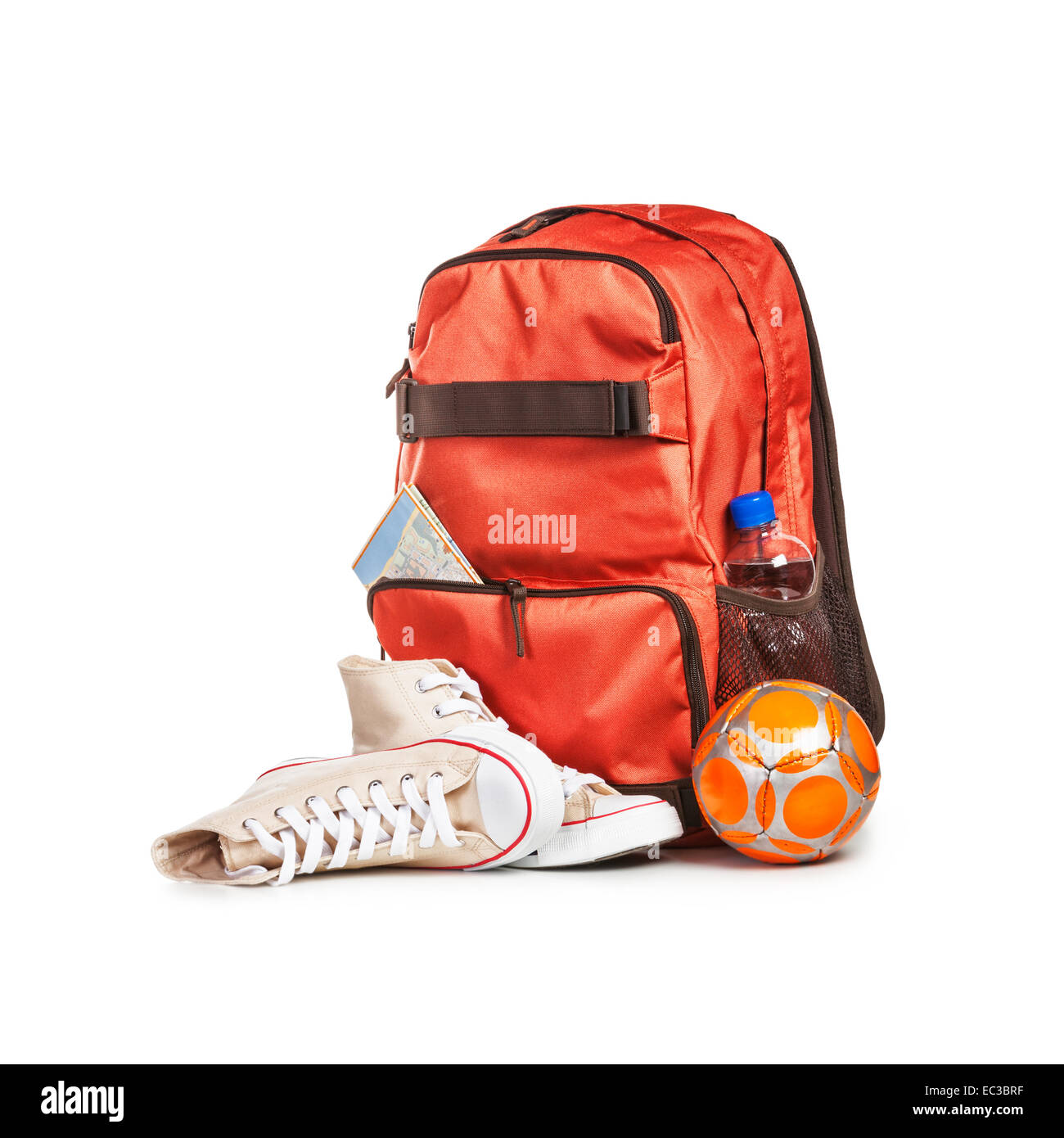 Backpack with bottle of water, ball, map and sport shoes isolated on white background. Tourism and travel themes. Clipping path Stock Photo
