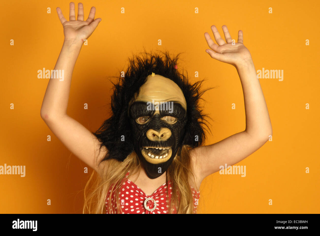 Girl wearing monkey mask Stock Photo