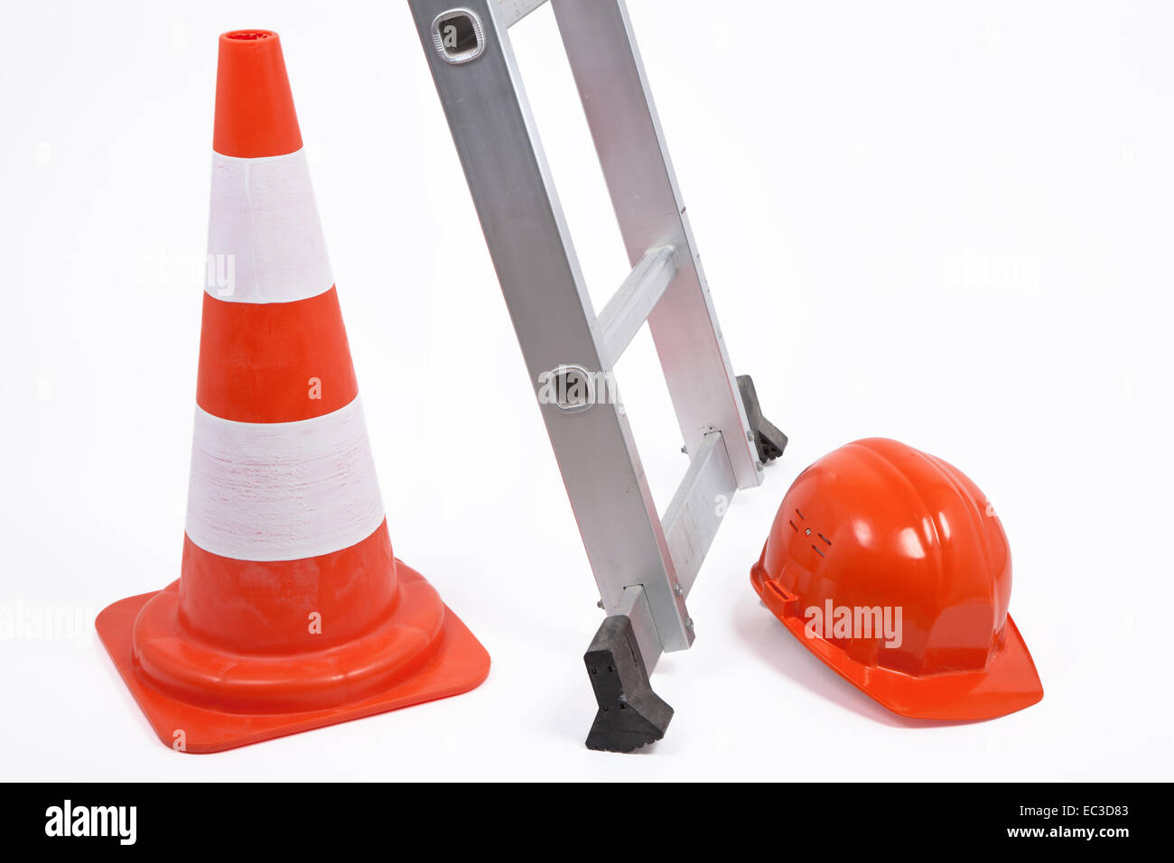 Traffic cone, ladder and hardhat Stock Photo