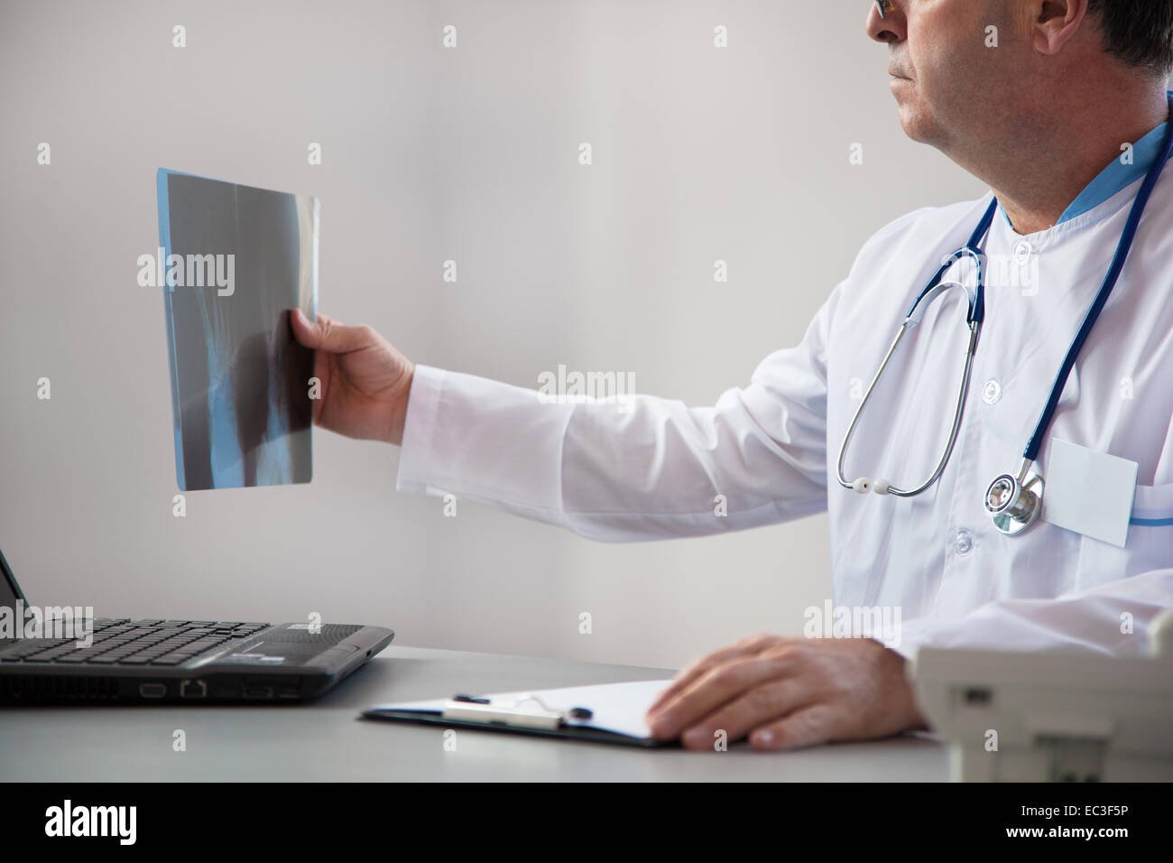 Doctor Is Reviewing A X-ray In The Clinic Stock Photo