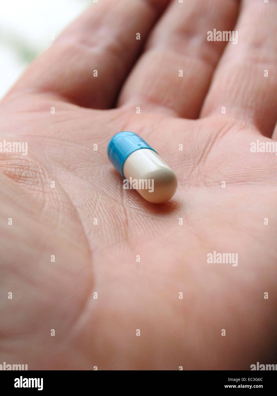 Hand throwing pills down a toilet Stock Photo - Alamy