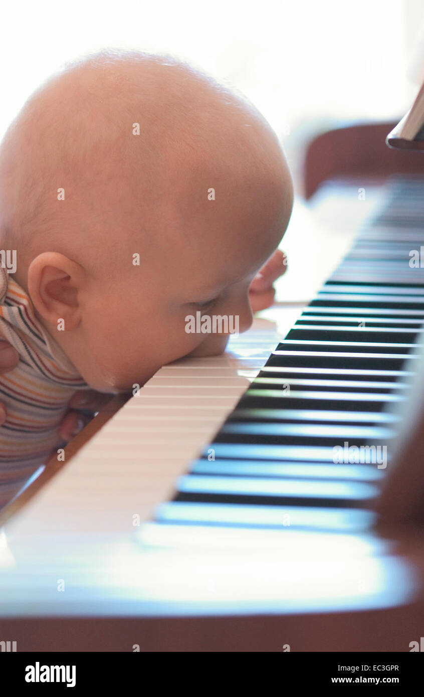 Baby playing Piano Stock Photo