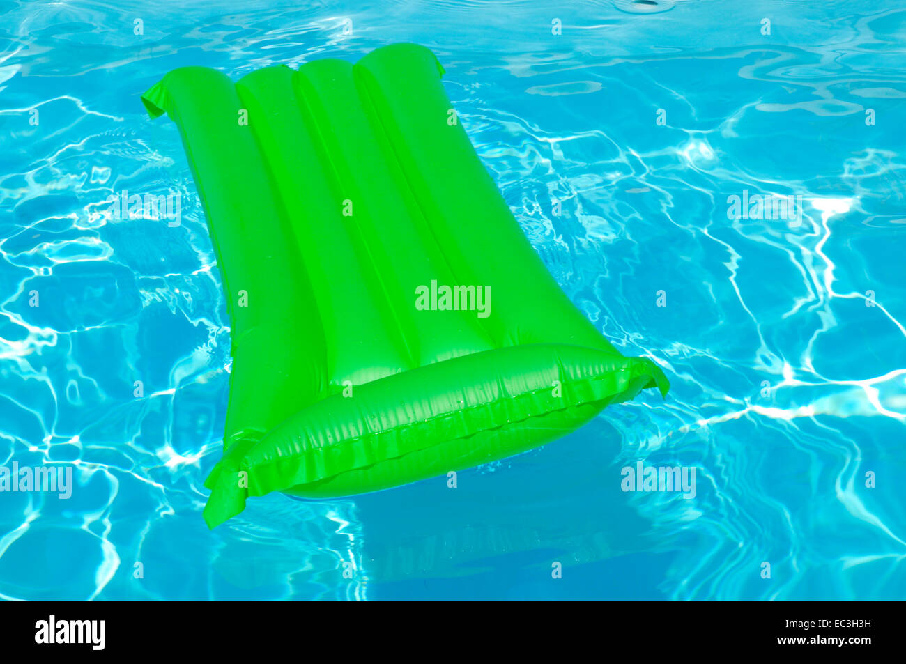Swimmingpool with airbed Stock Photo