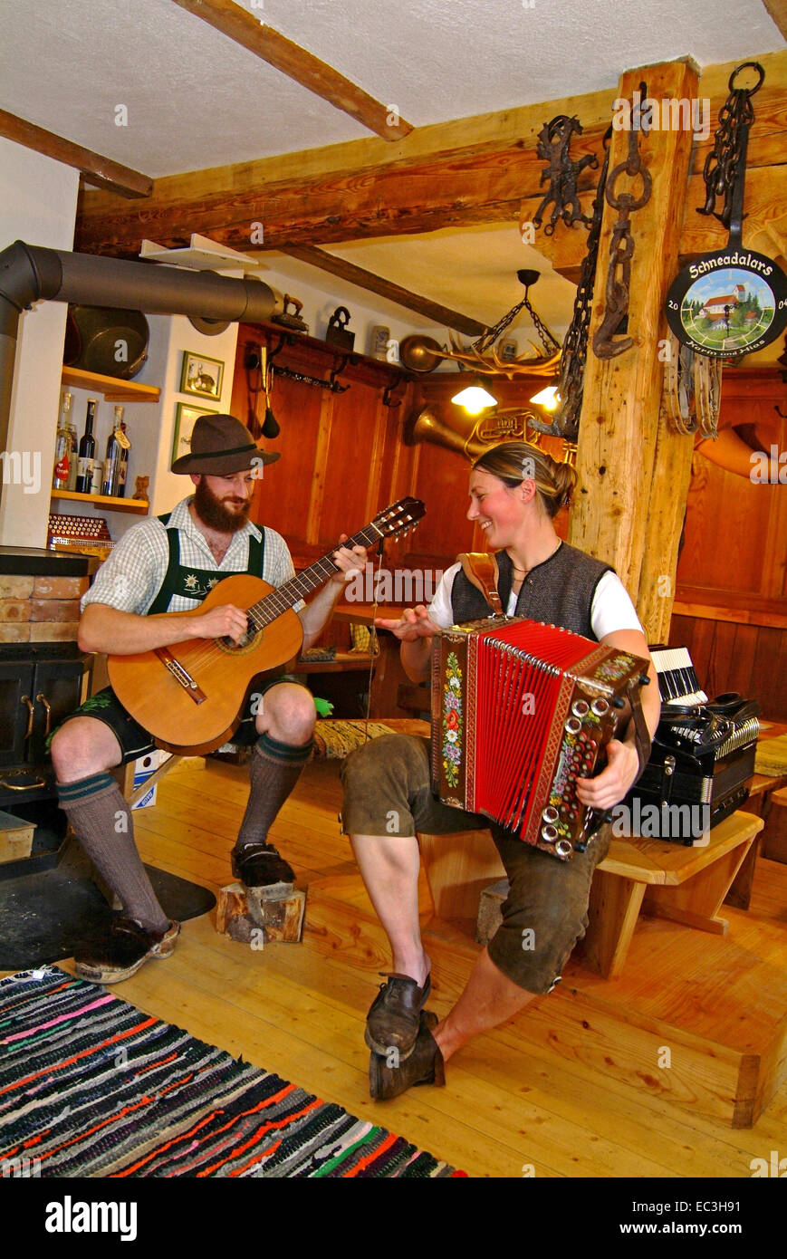 Man with guitar and Woman with Accordion in Traditional Costume Stock