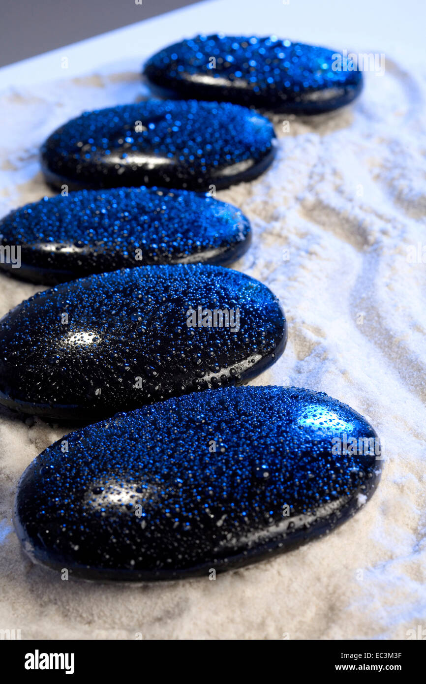 Five black Stones in a Row Stock Photo Alamy