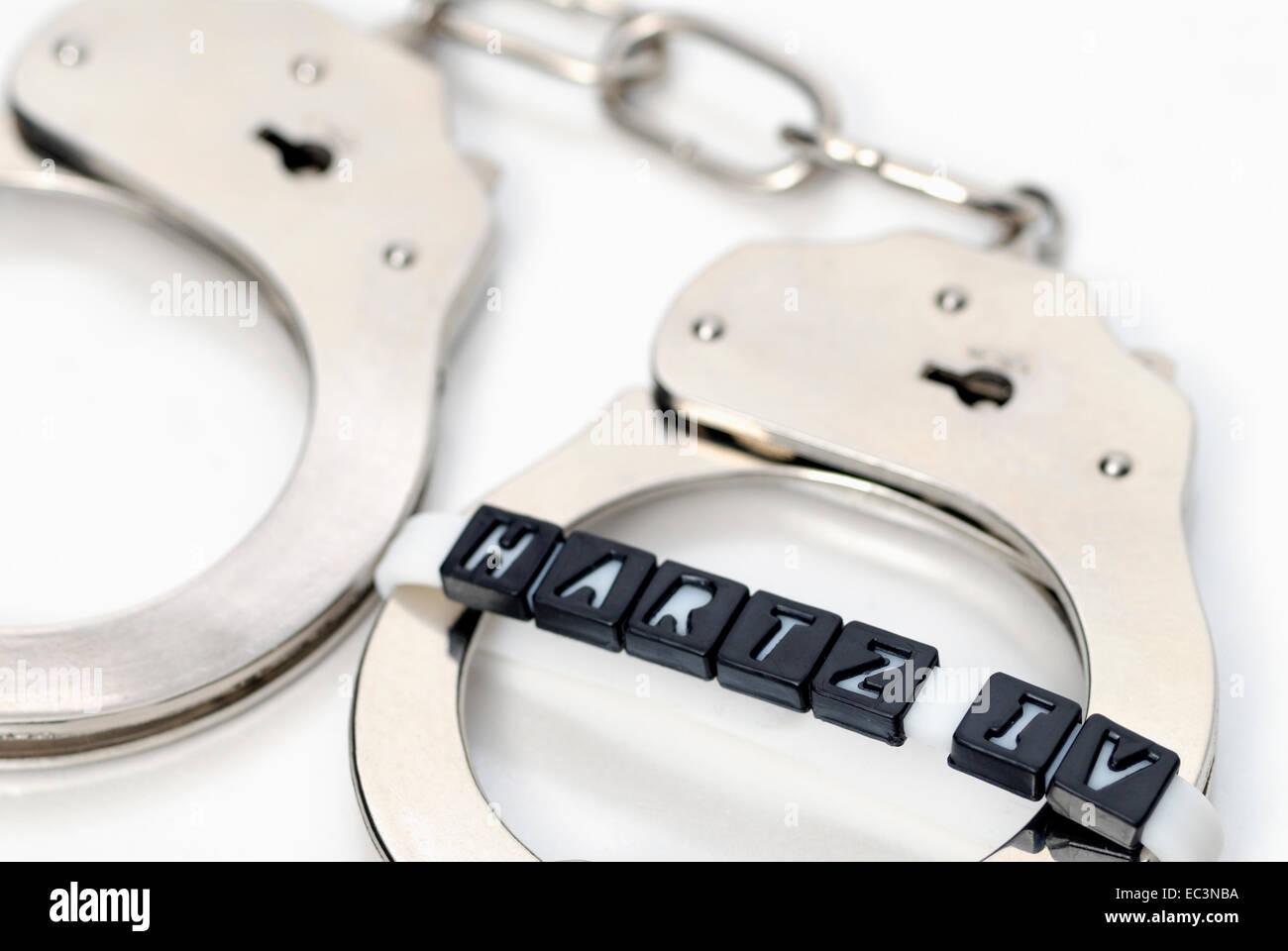 Handcuffs with label Hartz IV, German unemployment benefit Stock Photo