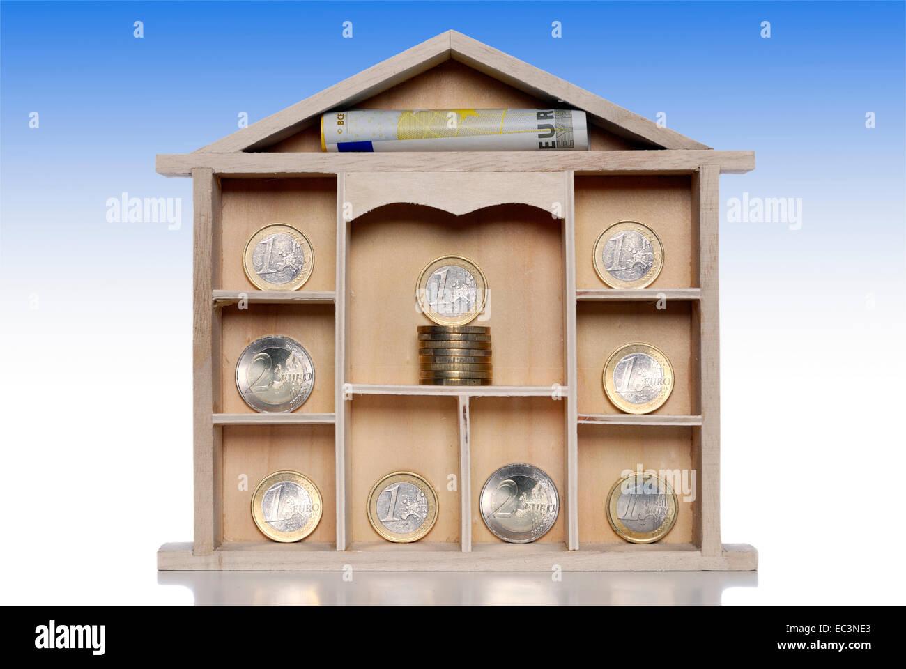 Miniature house with euro coins, housing benefit Stock Photo