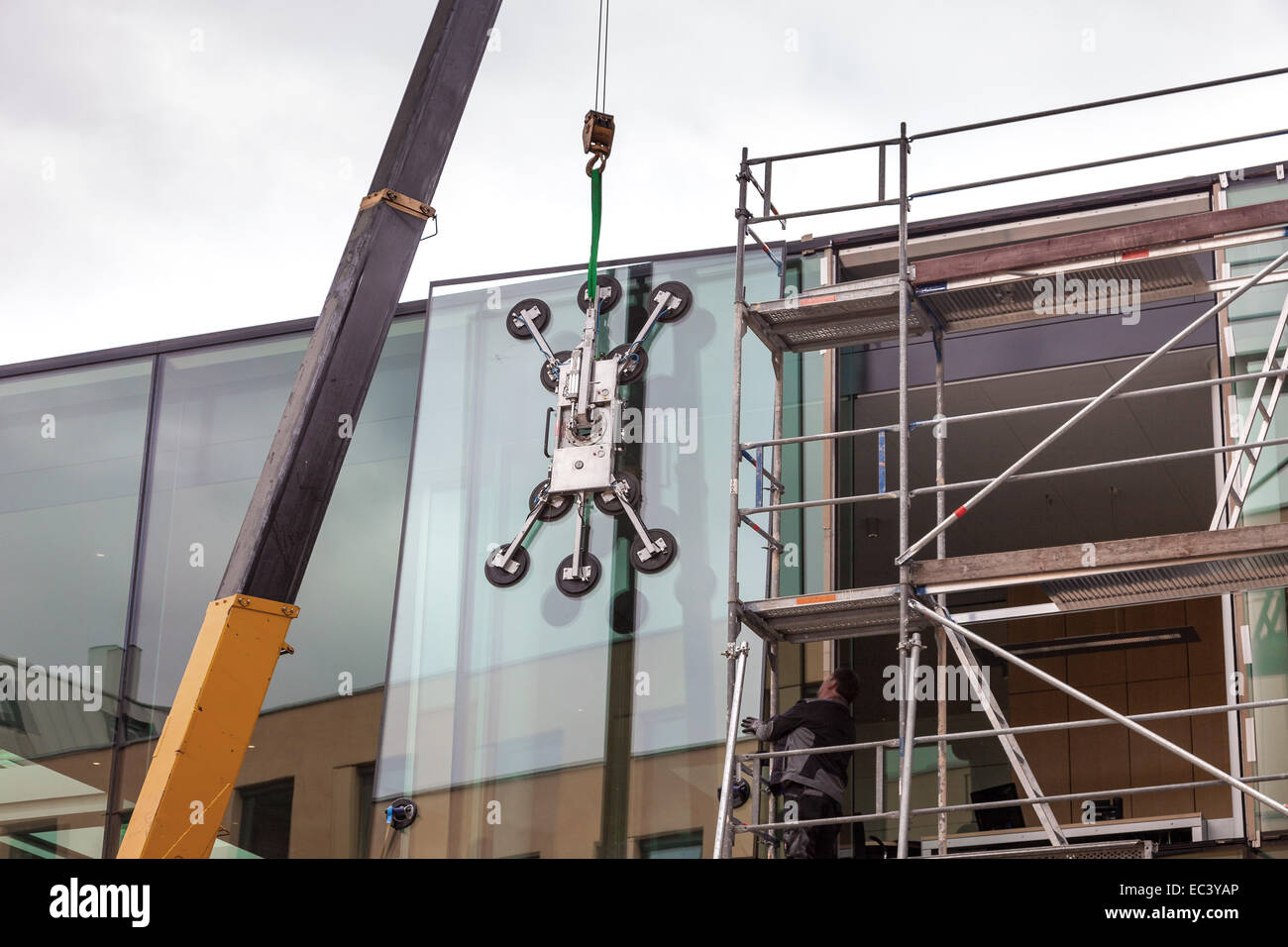 Crane for lifting and inserting a heavy glass plate Stock Photo Alamy