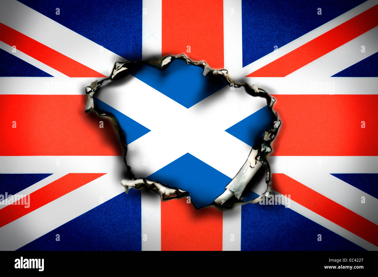 Union Jack, burn hole and flag of Scotland, Scottish eagerness for independence Stock Photo