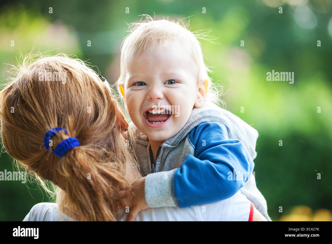 Mother holding happy screaming boy Stock Photo