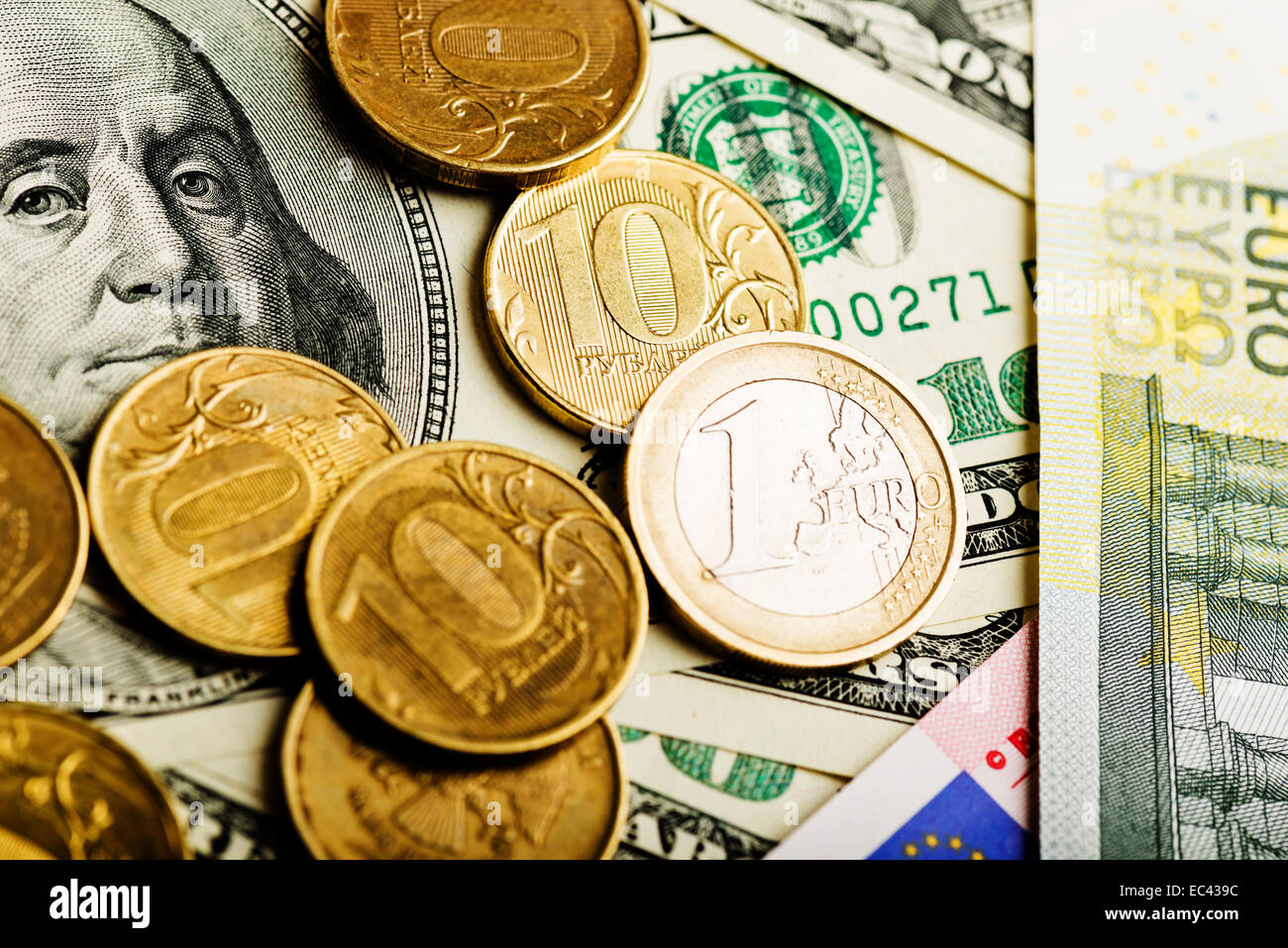 russian roubles coins and euro coin on banknotes of dollars and Stock ...