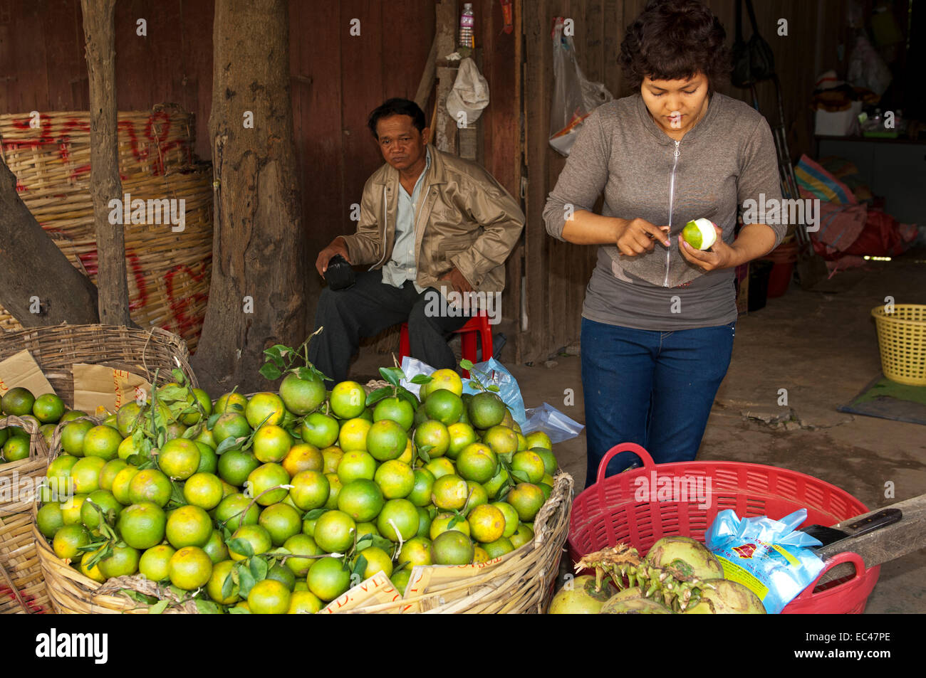 Baskets full of oranges at a fruit vendor at a vegetable market, Battambang, Cambodia Stock Photo