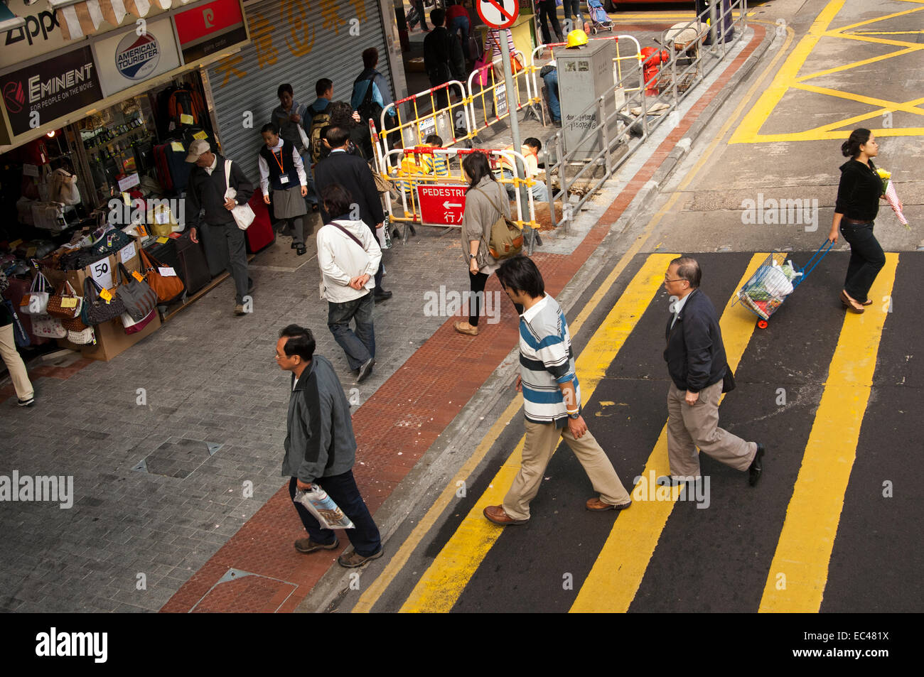 Pedestrians on a zebra crossing with yellow stripes, Hong Kong Stock