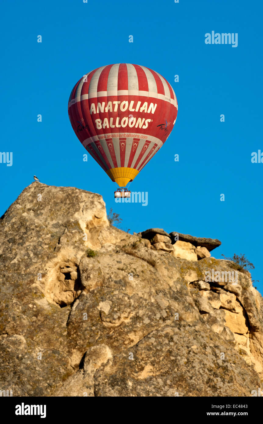 Hot air balloon hovering over the rock sites of Cappadocia, Goereme, Turkey Stock Photo