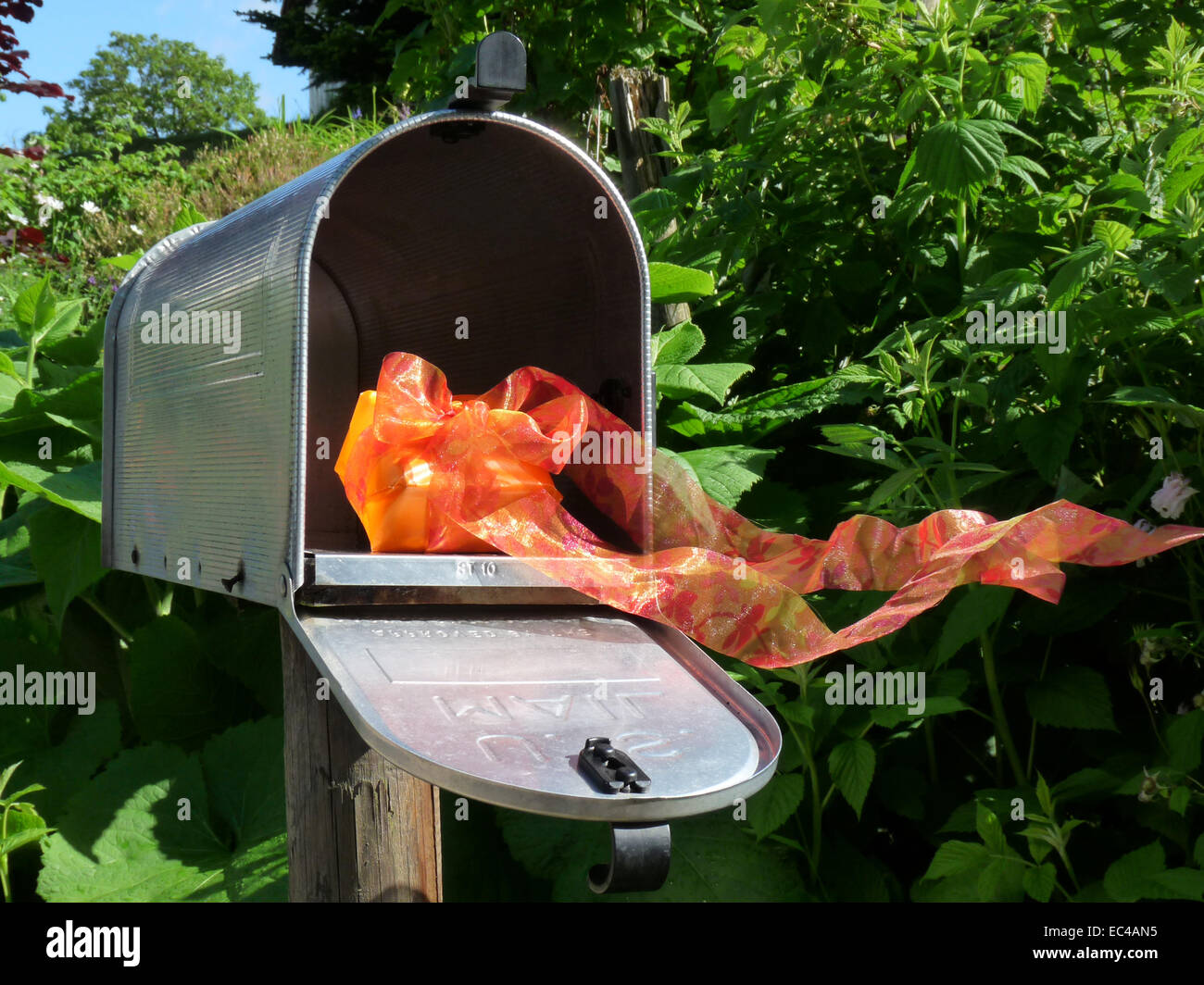 present in a letterbox Stock Photo