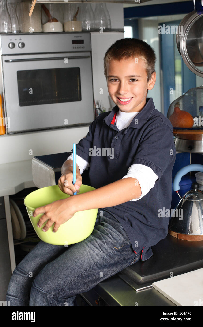 Boy in Kitchen Mixing in a Bowl Stock Photo - Alamy