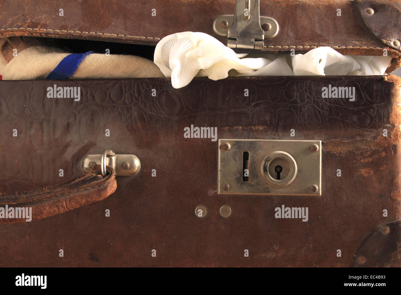 sloppy packed old leather suitcase Stock Photo