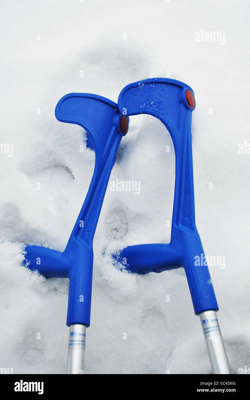 Crutches lying in snow Stock Photo Alamy