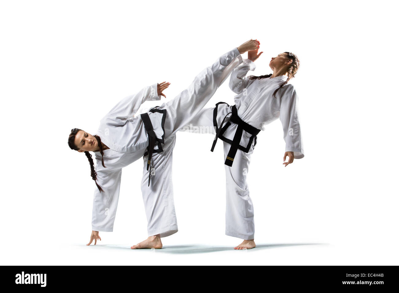 Two isolated professional female karate fighters are fighting Stock