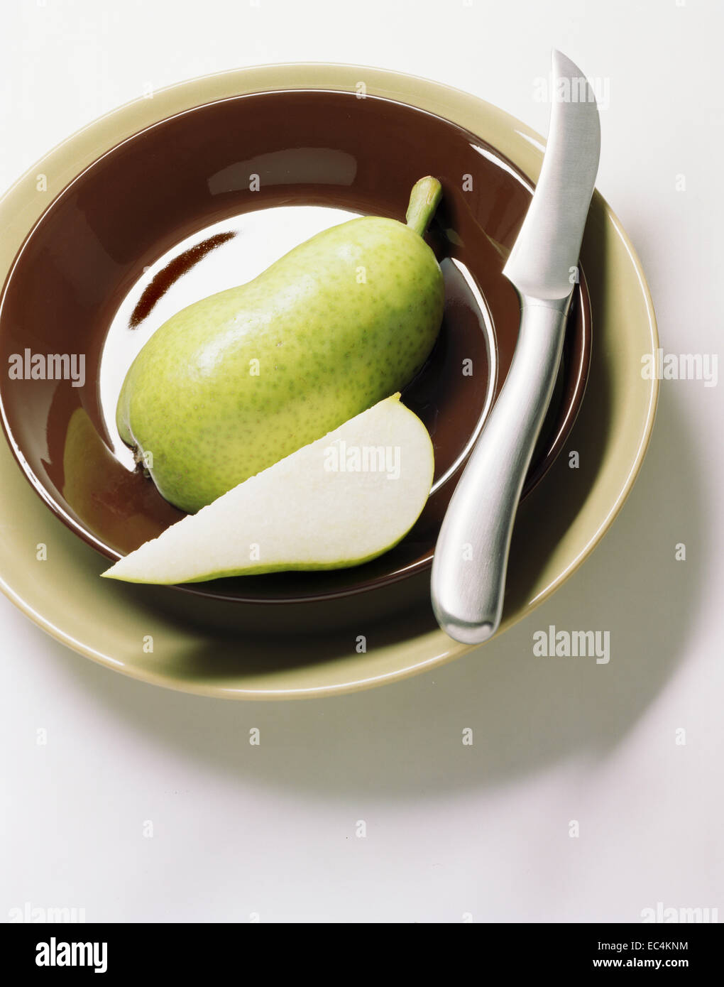 Plate with pear and knife Stock Photo