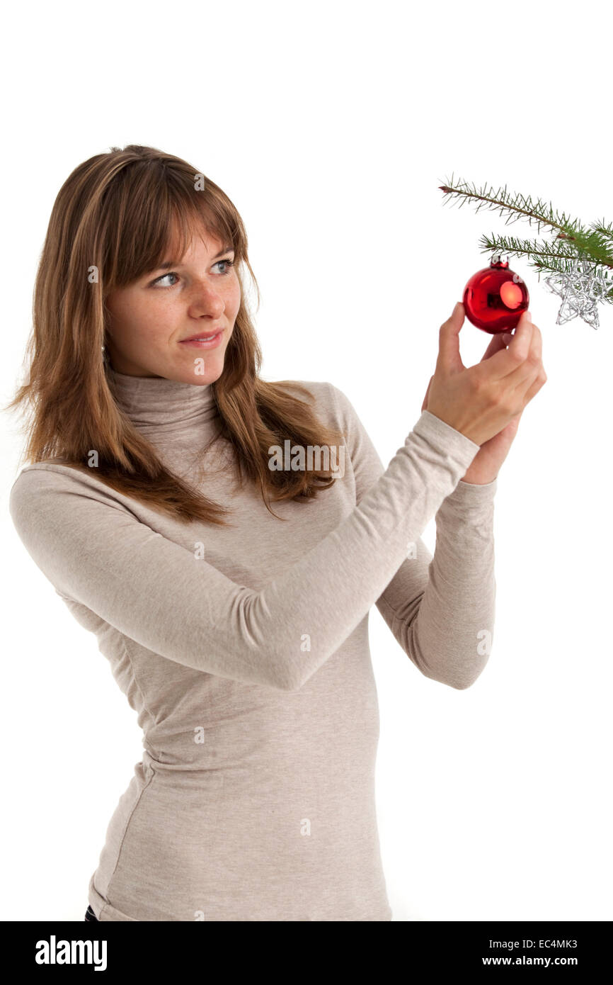 Pretty Young Woman decorating the Christmas Tree Stock Photo
