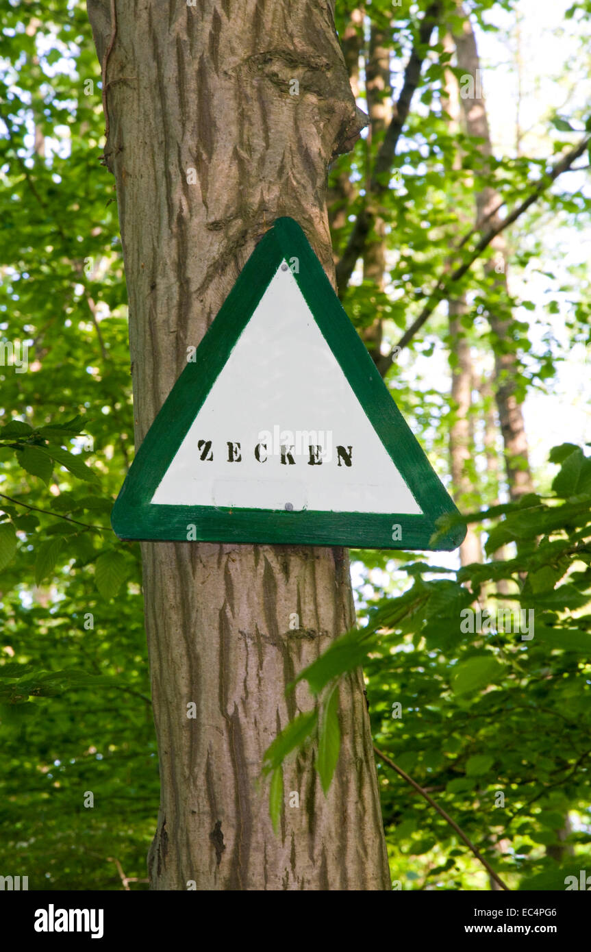danger ticks sign in a forest Stock Photo