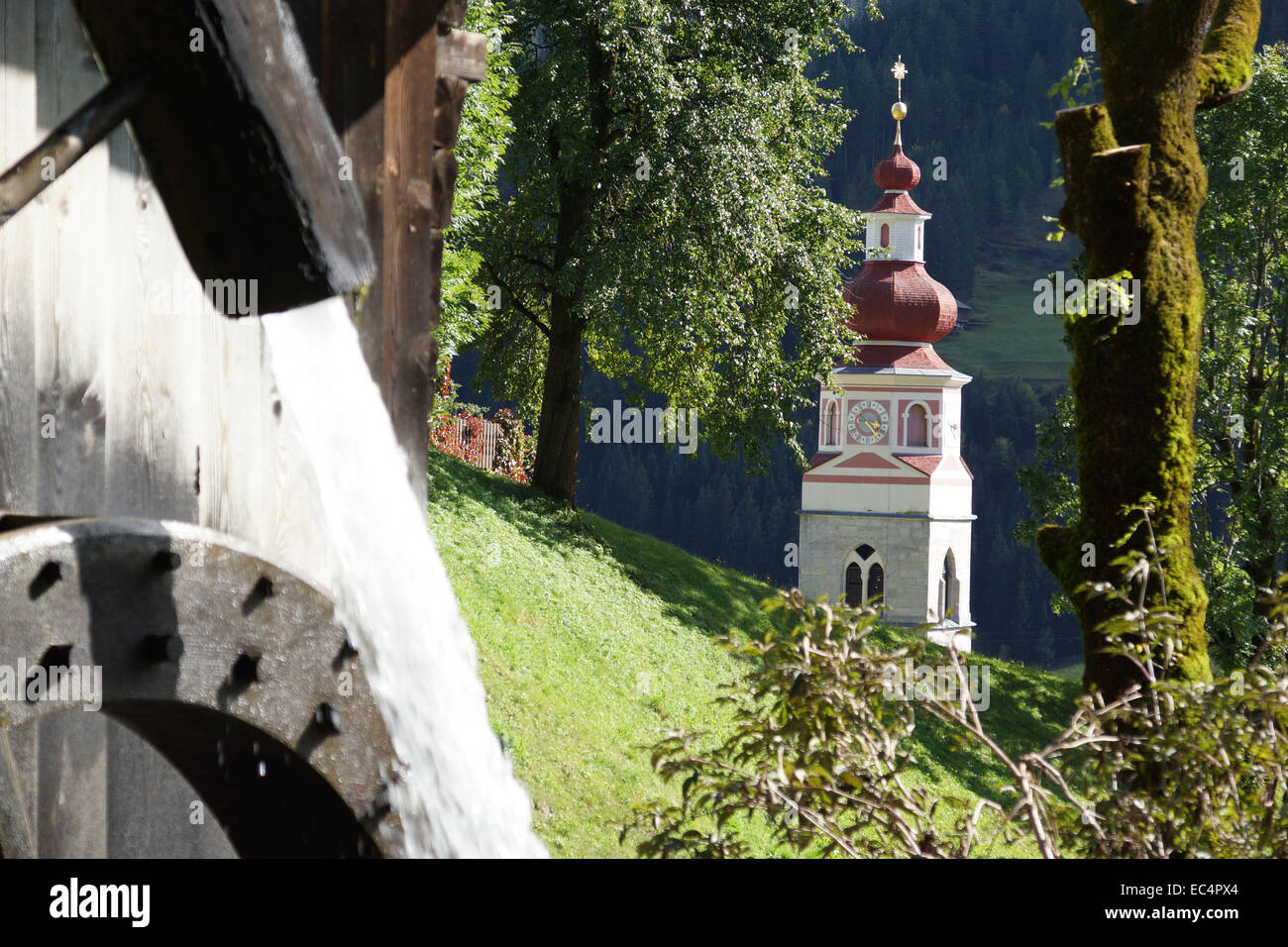 Steeple and water mills on Trattenbach Stock Photo