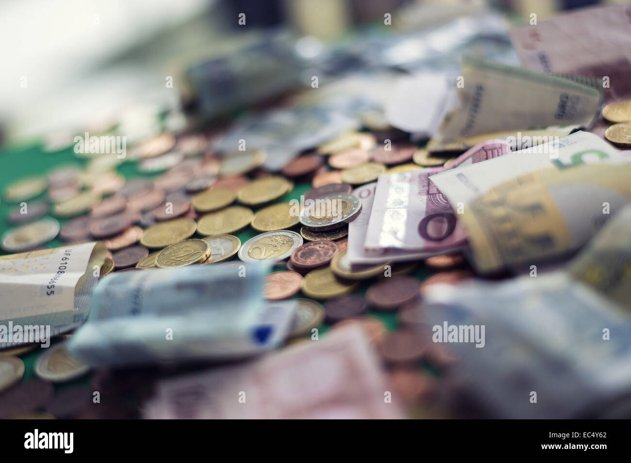 Small change, coins and bank notes are messed up Stock Photo Alamy