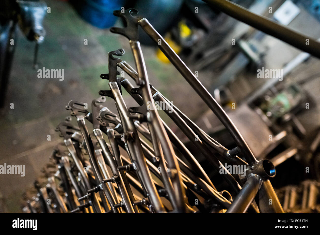 Recently welded bike frames are seen piled up in a small scale bicycle factory in Bogota, Colombia, 10 April 2013. Due to the strong, vibrant cycling culture in Colombia, with cycling being one of the two most popular sports in the country, dozens of bike workshops and artisanal, often family-run bicycle factories were always spread out through the Colombian cities. However, growing import of cheap bicycles and components from China during the last decade has led to a significant decline in domestic bicycle production. Traditional no-name bike manufacturers are forced to close down their facto Stock Photo