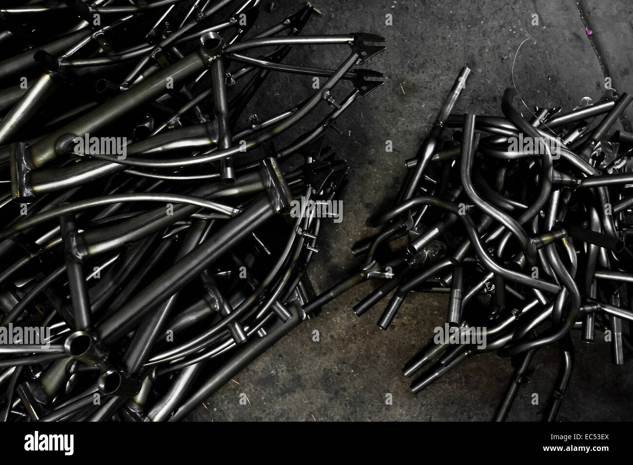 Recently welded bike frames are seen piled up in a small scale bicycle factory in Cali, Colombia, 27 June 2014. Due to the strong, vibrant cycling culture in Colombia, with cycling being one of the two most popular sports in the country, dozens of bike workshops and artisanal, often family-run bicycle factories were always spread out through the Colombian cities. However, growing import of cheap bicycles and components from China during the last decade has led to a significant decline in domestic bicycle production. Traditional no-name bike manufacturers are forced to close down their factorie Stock Photo