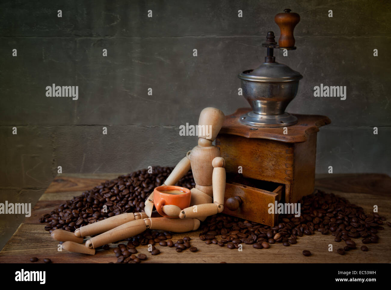 Still Life with Coffee grinder and jointed doll working the mill Stock Photo