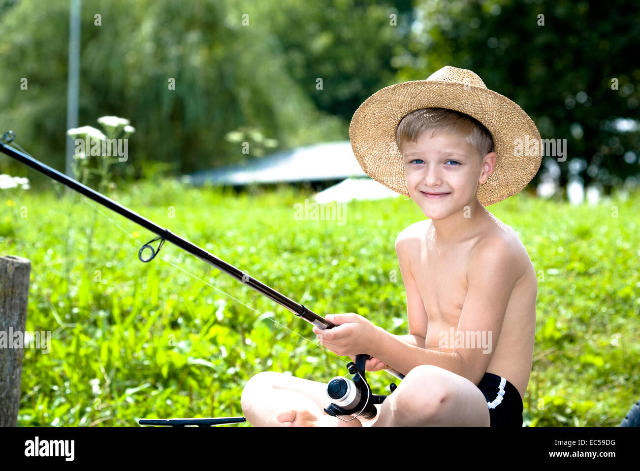 a young angler fishing in the river Stock Photo
