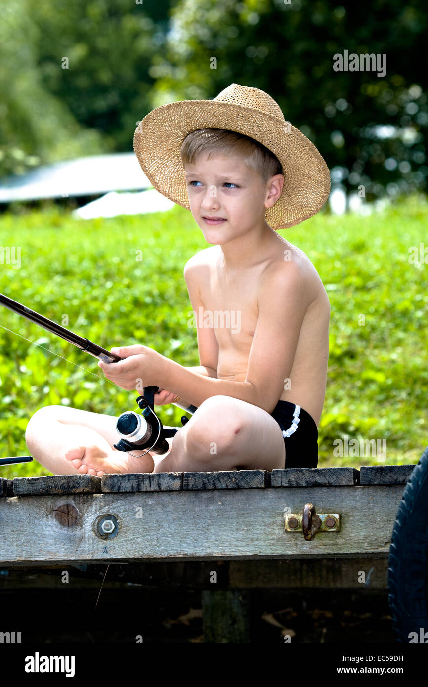 a young angler fishing in the river Stock Photo