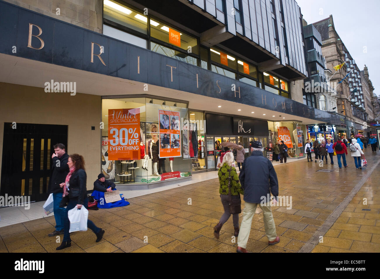 BRITISH HOME STORES BHS department store with homeless beggar outside