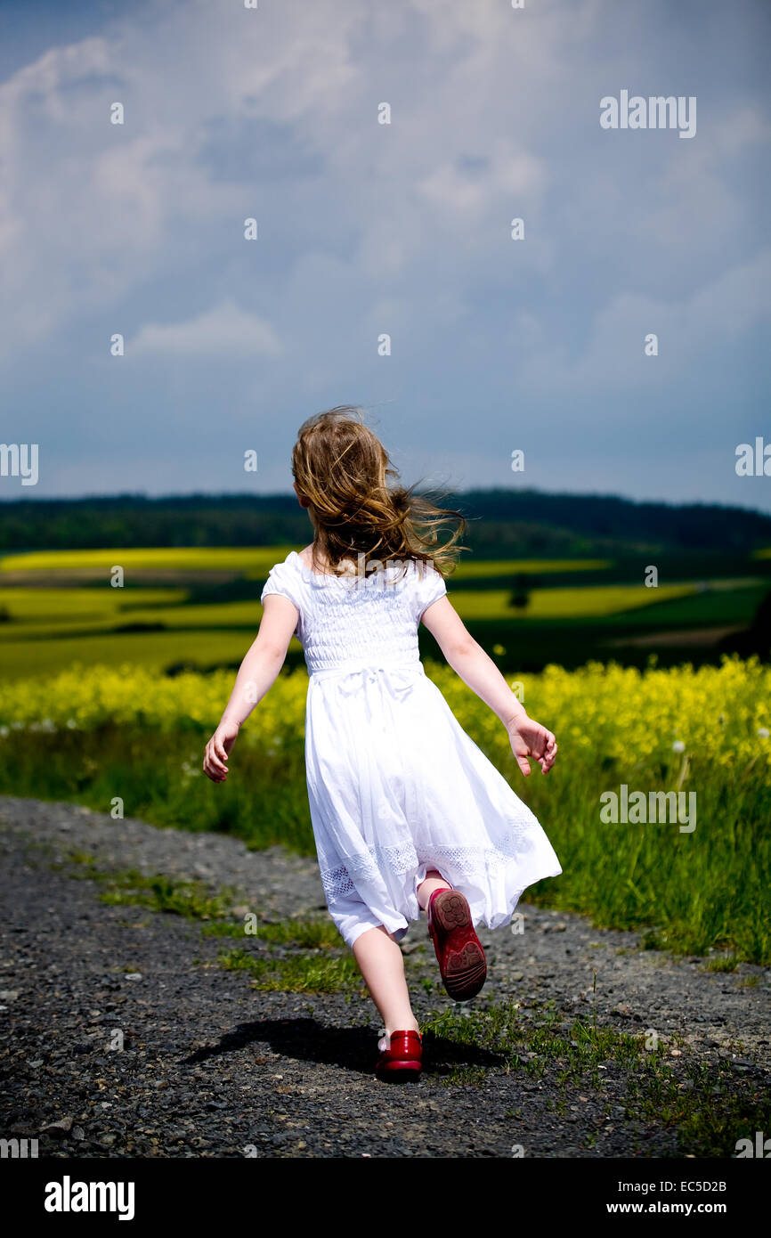 little girls walking and ranking the fields Stock Photo - Alamy