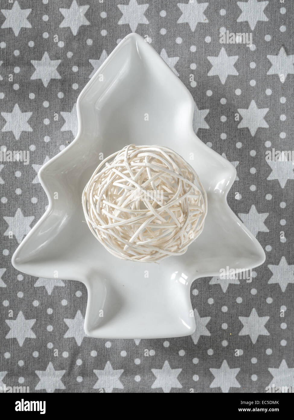 Christmas string ball ornament on white tree-shaped plate Stock Photo