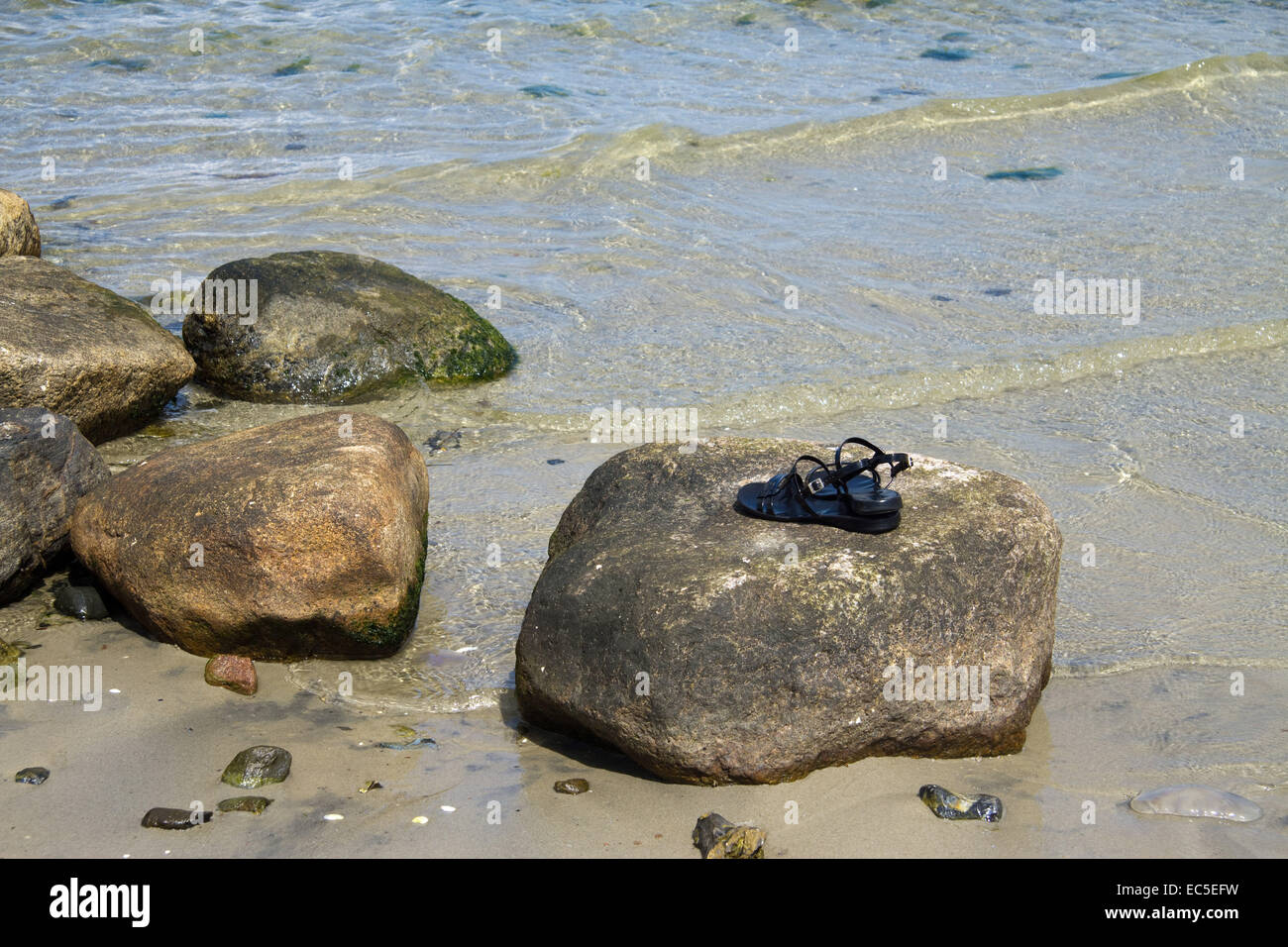 forgotten sandals, still-life at the sea Stock Photo