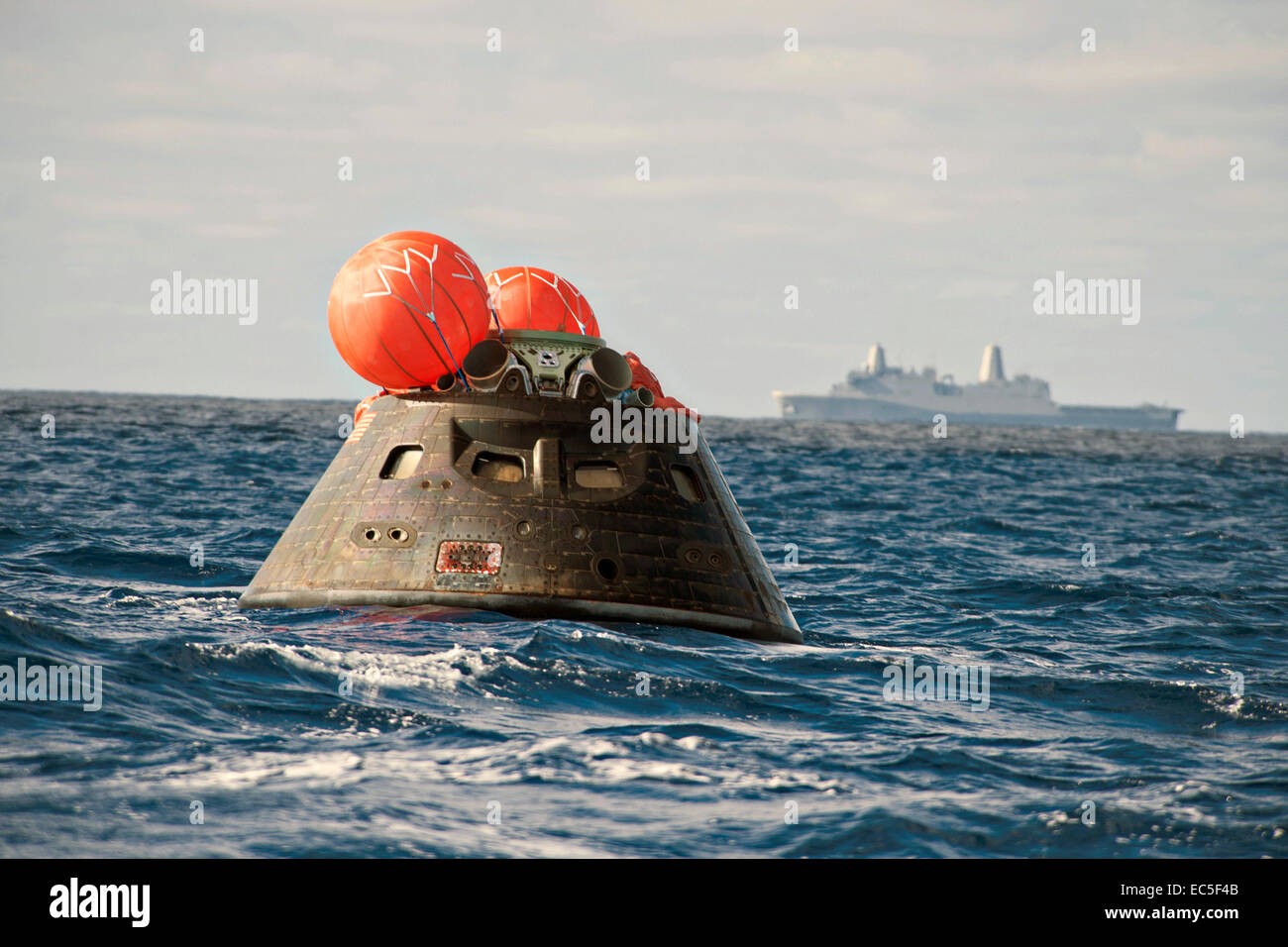 US Navy sailors from the amphibious transport dock ship USS Anchorage recover the NASA Orion space capsule during the second at-sea testing for the crew module using a well deck recovery August 3, 2014 off the coast of California. Stock Photo