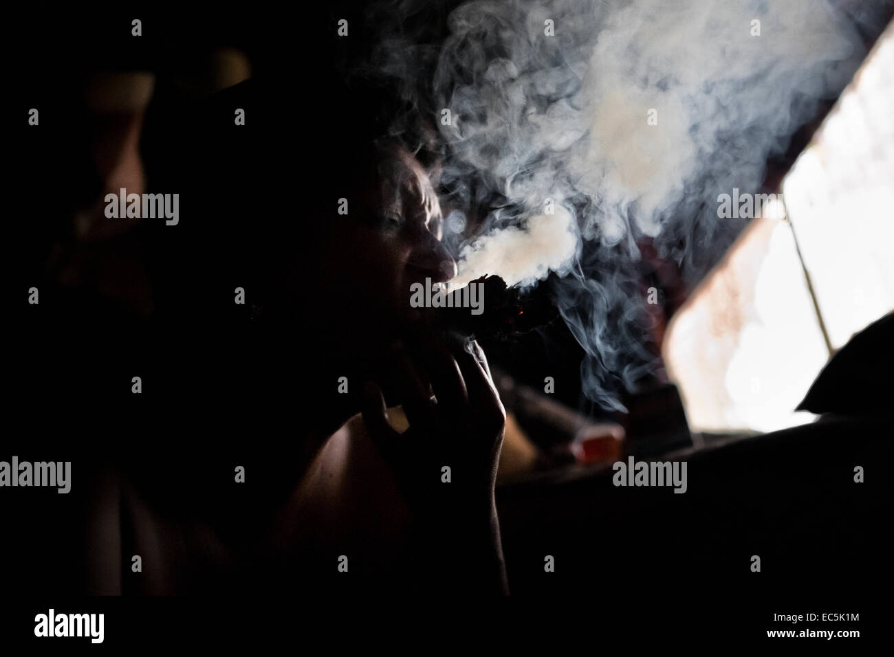 A Colombian woman puffs three cigars to devine the future from burn ...