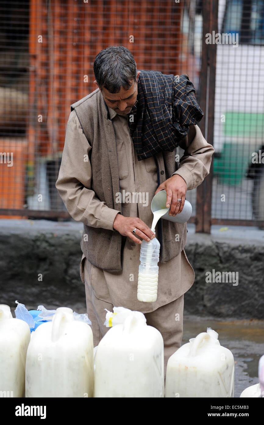 Indian man sell milk in the market Stock Photo Alamy
