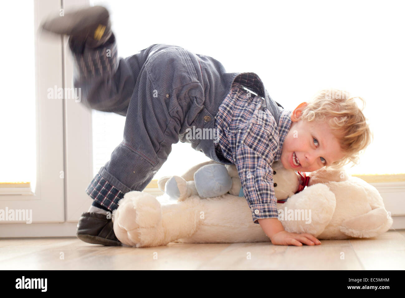 Boy plays with his teddy bear Stock Photo - Alamy