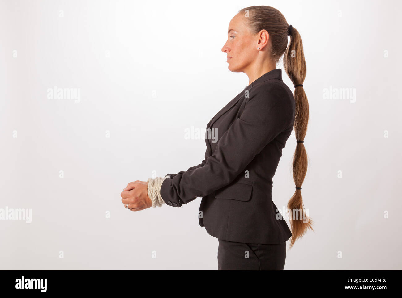 The hands of a young woman are handcuffed Stock Photo