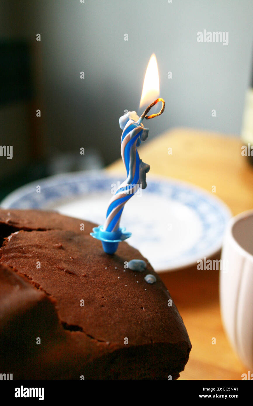 birthday candle on chocolate cake Stock Photo - Alamy