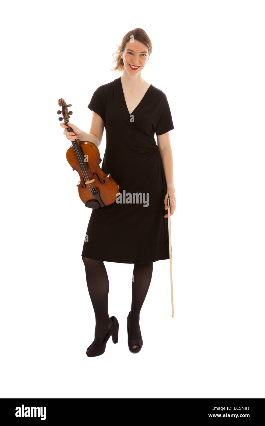 The beautiful young woman is holding a violin in her hand Stock Photo