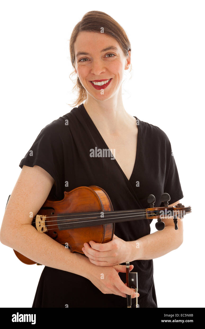 The beautiful young woman is holding a violin in her hand Stock Photo