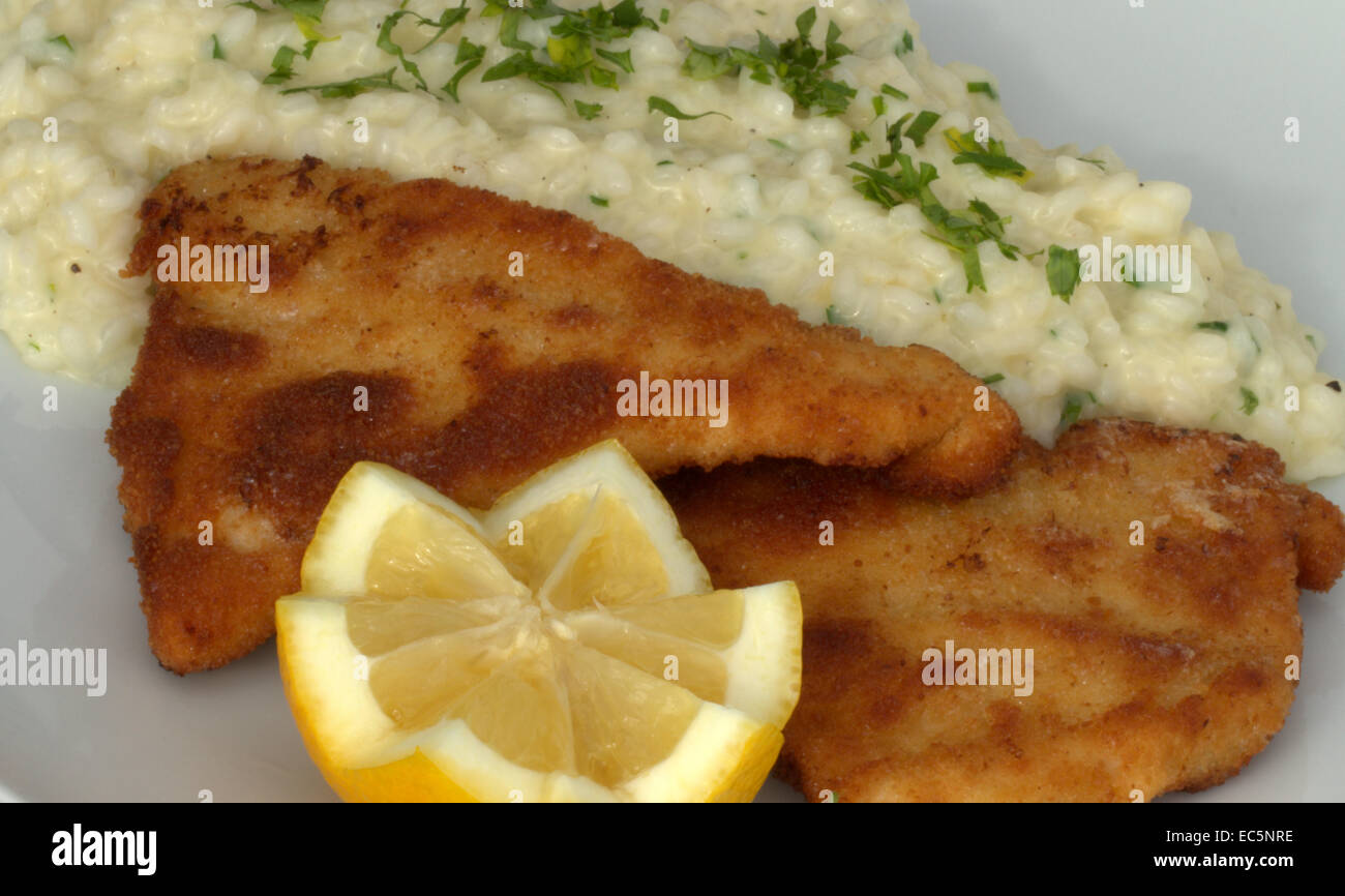 breaded fish with italien rice Stock Photo Alamy