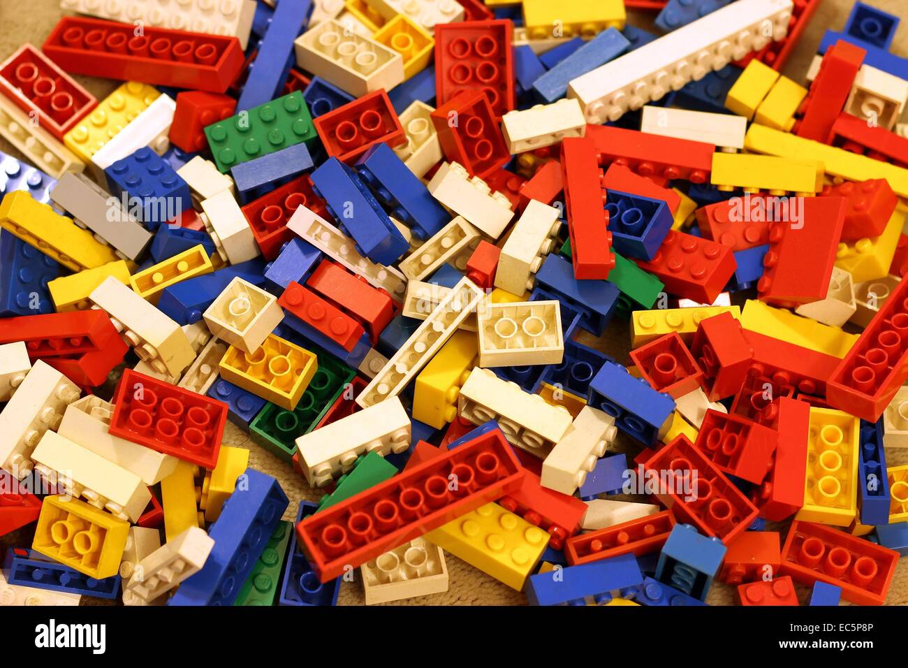 Lego pieces on carpet Stock Photo
